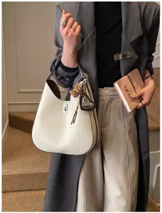 Elegant white shoulder hobo bag with metal lock and cute charms for women daily commute stylish use.