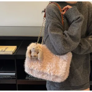 Winter plush shoulder bag for women, cute pink fluffy crossbody bag with chain and rabbit.