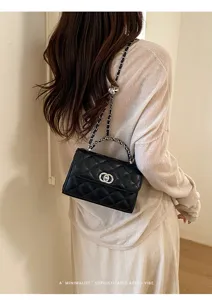 Classic black quilted chain shoulder bag detail shot worn by model, elegant retro vibe style.