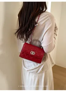 Red quilted chain crossbody bag detail shot showing leather texture and retro style vibe.