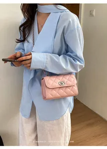 Detailed shot of a stylish pink quilted chain shoulder bag worn with casual outfit.