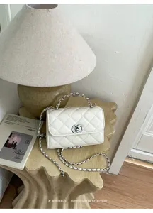 White quilted chain shoulder bag detail shot, chic retro square crossbody bag with metal strap.
