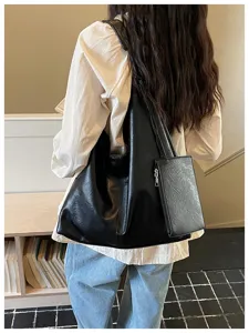 Black soft leather shoulder bag detail, minimalist slouchy hobo tote with pouch.