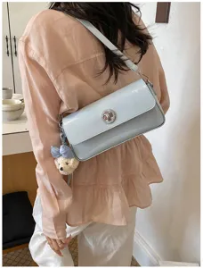 Light blue PU leather shoulder bag for women, stylish minimalist crossbody bag with lock.