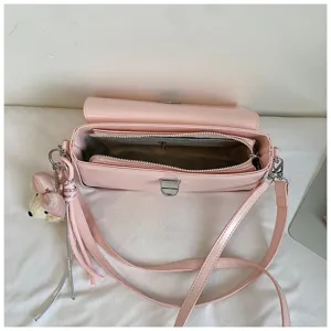 Pink leather shoulder bag interior detail showing zipper pocket and spacious main compartment.