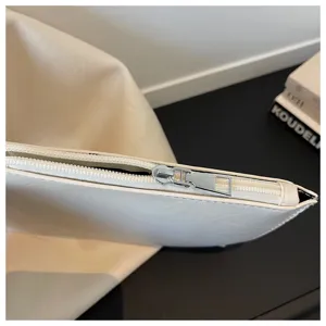 Detailed view of women soft leather casual tote bag zipper craftsmanship minimalist style.