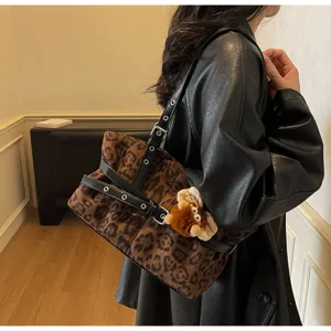 Vintage leopard print suede shoulder bag with black leather straps and cute plush pendant.