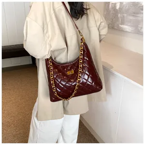 Burgundy quilted chain shoulder bag, stylish crossbody purse with chunky gold hardware details.