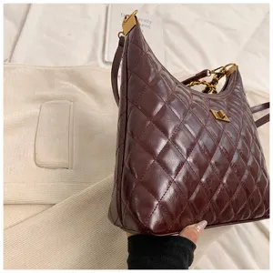 Wine red quilted hobo shoulder bag detail, stylish chain strap and chic turn-lock design.