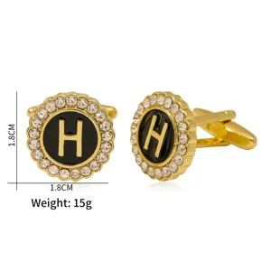 Elegant gold metal cufflinks featuring a black round insert with rhinestone border and letter H.