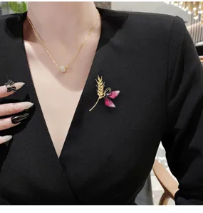 Exquisite wheat ear butterfly brooch detail shot, elegant suit accessory and fashion lapel pin.