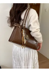 Detailed view of the retro brown shoulder tote bag featuring large capacity and elegant style.