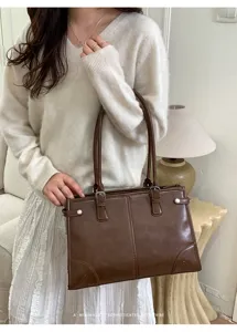 Retro large capacity shoulder tote bag for women, stylish brown PU leather commuting handbag.