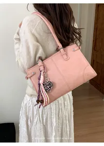 Stylish pink retro shoulder tote bag with cute heart keychain, perfect for daily commuting.