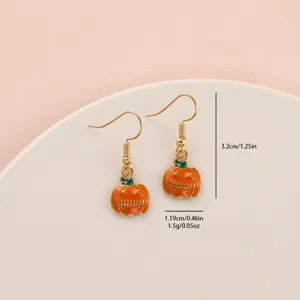 Closeup of Halloween evil pumpkin enamel hook earrings showing delicate craftsmanship and size.