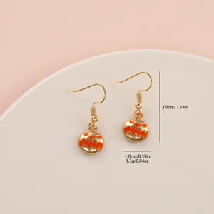 Halloween pumpkin drop earrings, cute gold-plated alloy holiday jewelry for women and girls.