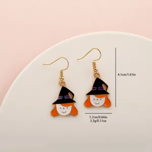 Close-up detail of Halloween witch earrings with cute hat and orange hair, alloy material.