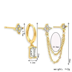 Detailed view of gold-plated four-leaf clover stud earrings with chain and geometric pendant.