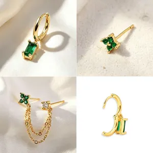 Detailed view of gold-plated green stone earrings featuring clover stud and chain design.