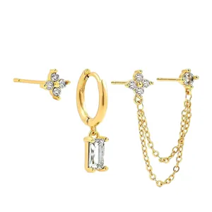 Gold-plated three-piece earring set featuring crystal floral studs and geometric chain drops.