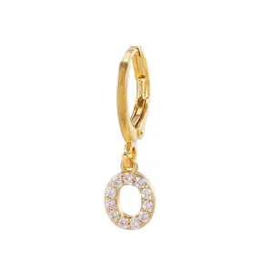 Gold plated letter O hoop earring close up, sparkling zircon crystal pave drop jewelry piece.