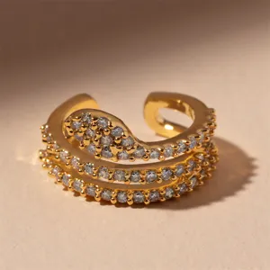 Gold micro-pave zirconia snake ear cuff, elegant minimalist fashion jewelry detail view.