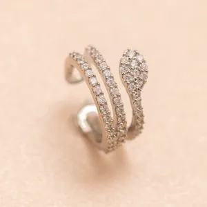 Close-up of a sparkling micro-pave cubic zirconia snake ear cuff, delicate wrap design details.