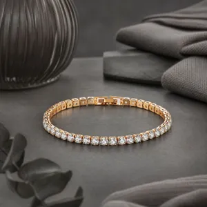 Elegant round zirconia tennis bracelet in gold tone, classic sparkling crystal wrist jewelry.
