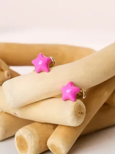 Pink star enamel stud earrings for women, cute copper alloy jewelry detail shot.