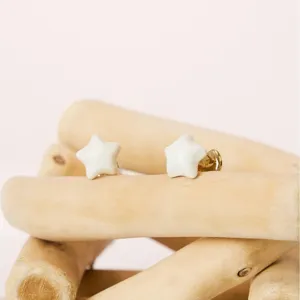 Minimalist white star stud earrings, elegant copper alloy enamel design for daily wear.