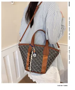 Detailed view of the Korean style checkered bucket bag with handles and shoulder strap.