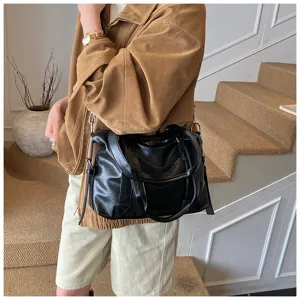 Vue détaillée du sac boston noir en cuir souple, élégant cabas pour le quotidien.