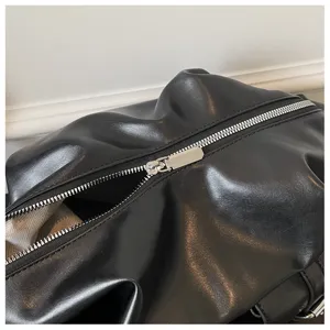 Detail shot of black soft leather backpack zipper, high quality minimalist daily bag.