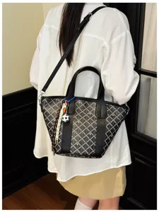 Detailed view of the women chevron pattern bucket shoulder bag with black leather trim.
