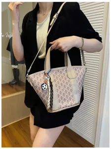 Stylish chevron pattern bucket tote bag with shoulder strap and charm for women commuting daily.
