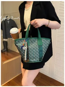 Green chevron pattern tote bag detail shot, stylish shoulder bag for women daily commute.