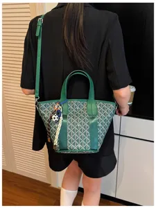 Green chevron bucket bag with top handles and shoulder strap for women daily commute.
