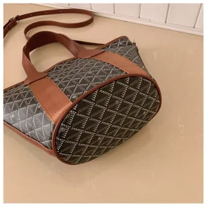 Classic chevron pattern bucket bag with brown leather trim, stylish daily shoulder bag for women.