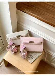 Retro crocodile pattern Kelly shoulder bag with cute bear pendant for daily commuting.