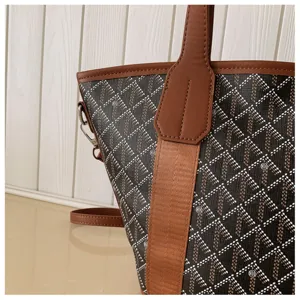 Women's chic bucket bag with stylish chevron pattern, brown top handle, and large daily capacity.