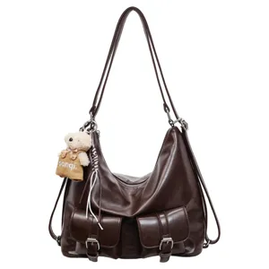 Vintage dark brown PU leather multi-use backpack and shoulder bag with front pockets.