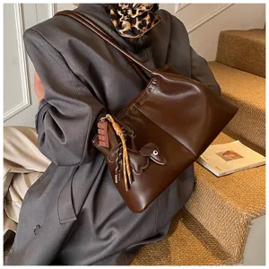 Casual brown leather tote bag for women, large capacity commuter shoulder handbag with charms.