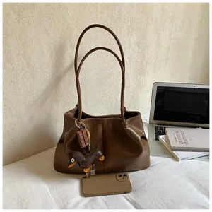 Brown leather tote bag with cute charm, large capacity stylish shoulder bag for women.