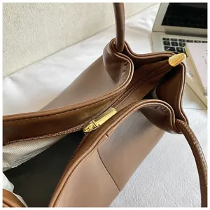 Brown leather tote bag for women, stylish large capacity commuter shoulder handbag.