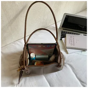 Detailed view of the brown leather tote bag showcasing large capacity interior space, commuter style.