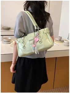 Detailed view of the stylish retro light green patent leather shoulder bag with charms.