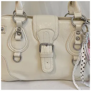 Retro white shoulder bag underarm tote vintage style chic handbag with metallic hardware.