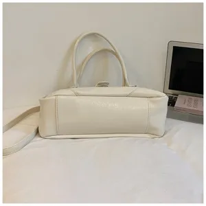 Detail view of the elegant white vintage shoulder bag featuring double handles and durable straps.