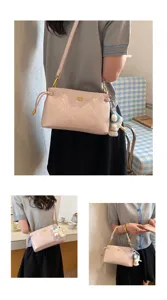 Stylish pink quilted underarm shoulder bag for women, trendy commuter crossbody bag with charm.