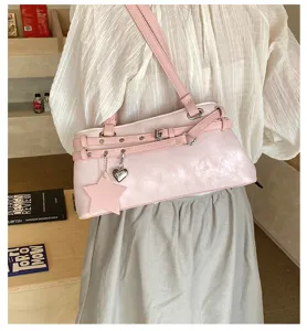 Pink shoulder bag detail, stylish PU leather underarm purse with star charm and metallic rings.